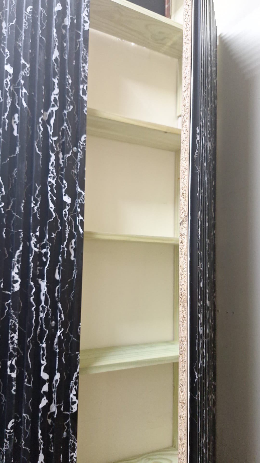 Close view of timber shelves inside concealed wall storage