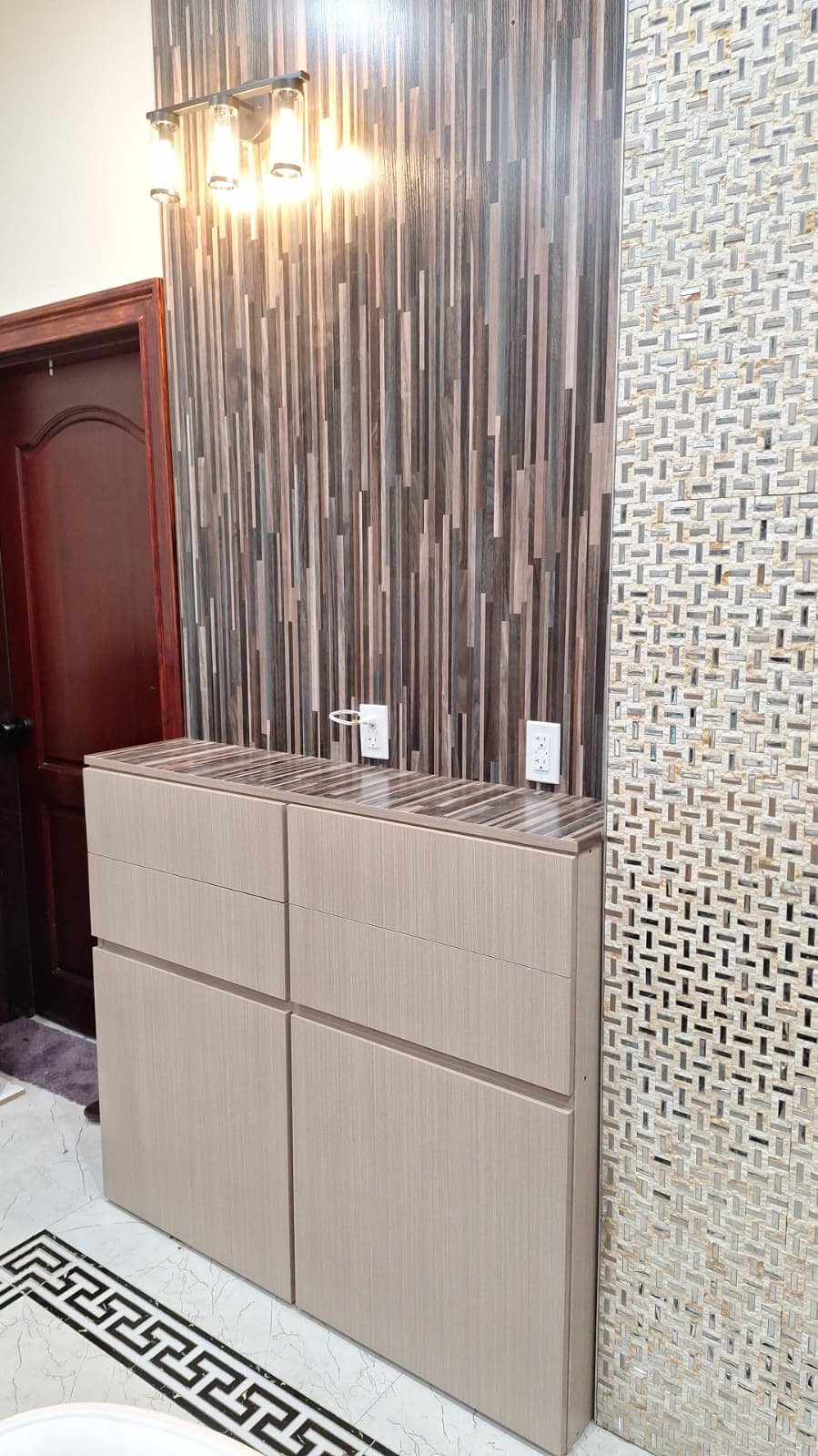 Fitted light wood-look console with flush drawers and coordinated wall panels
